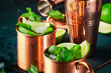 Moscow mule cocktail in copper mug with lime, ice, ginger beer,, a Food & Drink Photo by 5PH