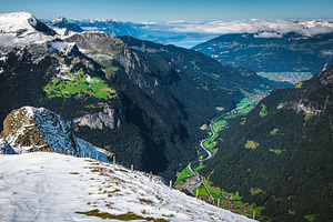 Green fields and snowy slopes, a Nature Photo by Alpine Dreams