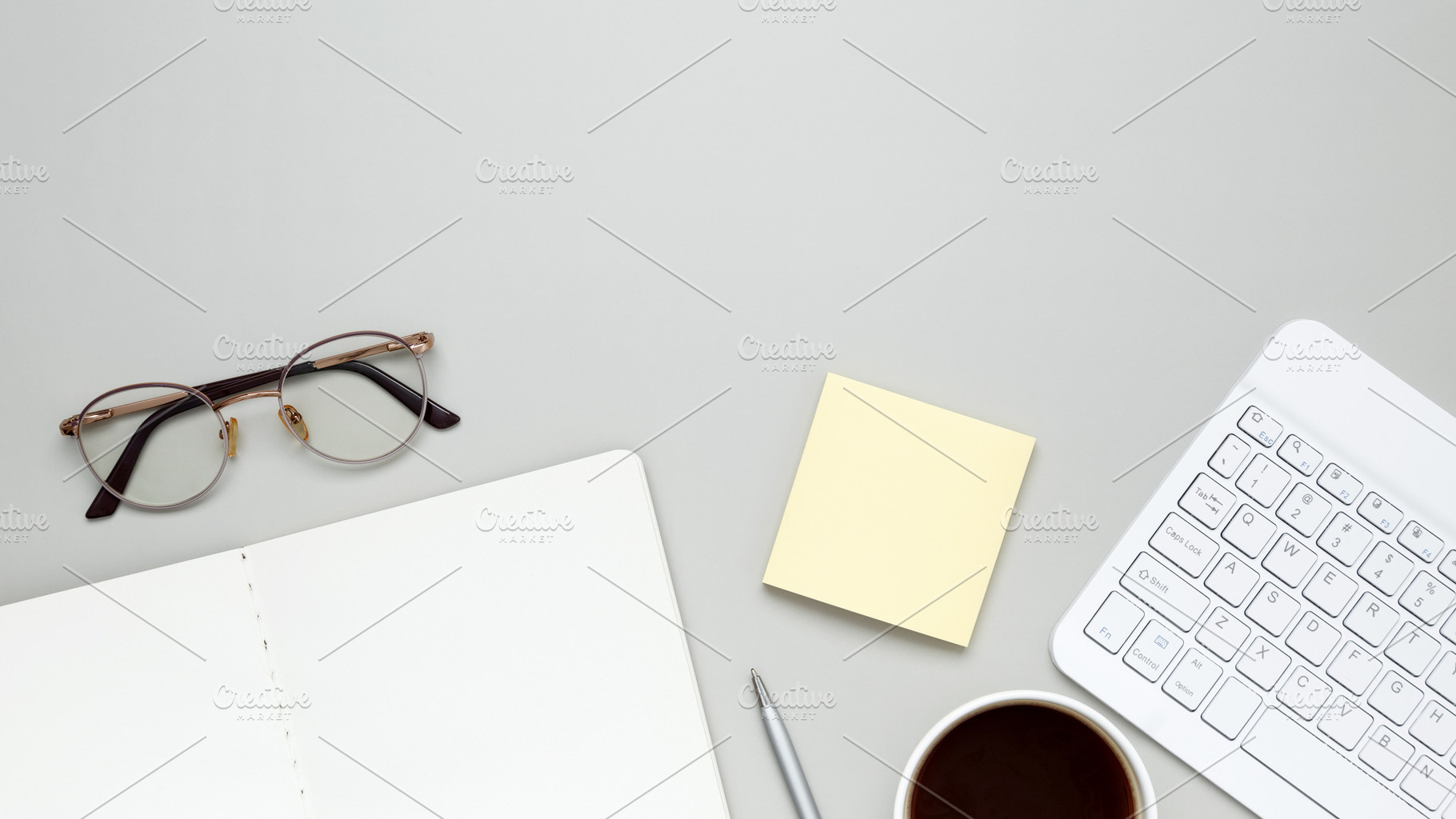 Organized workspace featuring keyboard, glasses, notebook, and stationery suppo, a Photo by matucha
