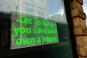 Bright green help sign in a shop window promoting mortgage and h, a Photo by AS photostudio