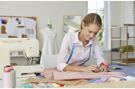 Young skillful seamstress woman, a Person Photo by StudioRomantic