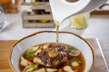 Oxtail soup being served in a restaurant