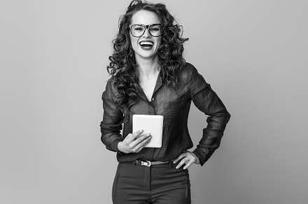 smiling young woman against background with tablet PC, a Person Photo by Alliance Images