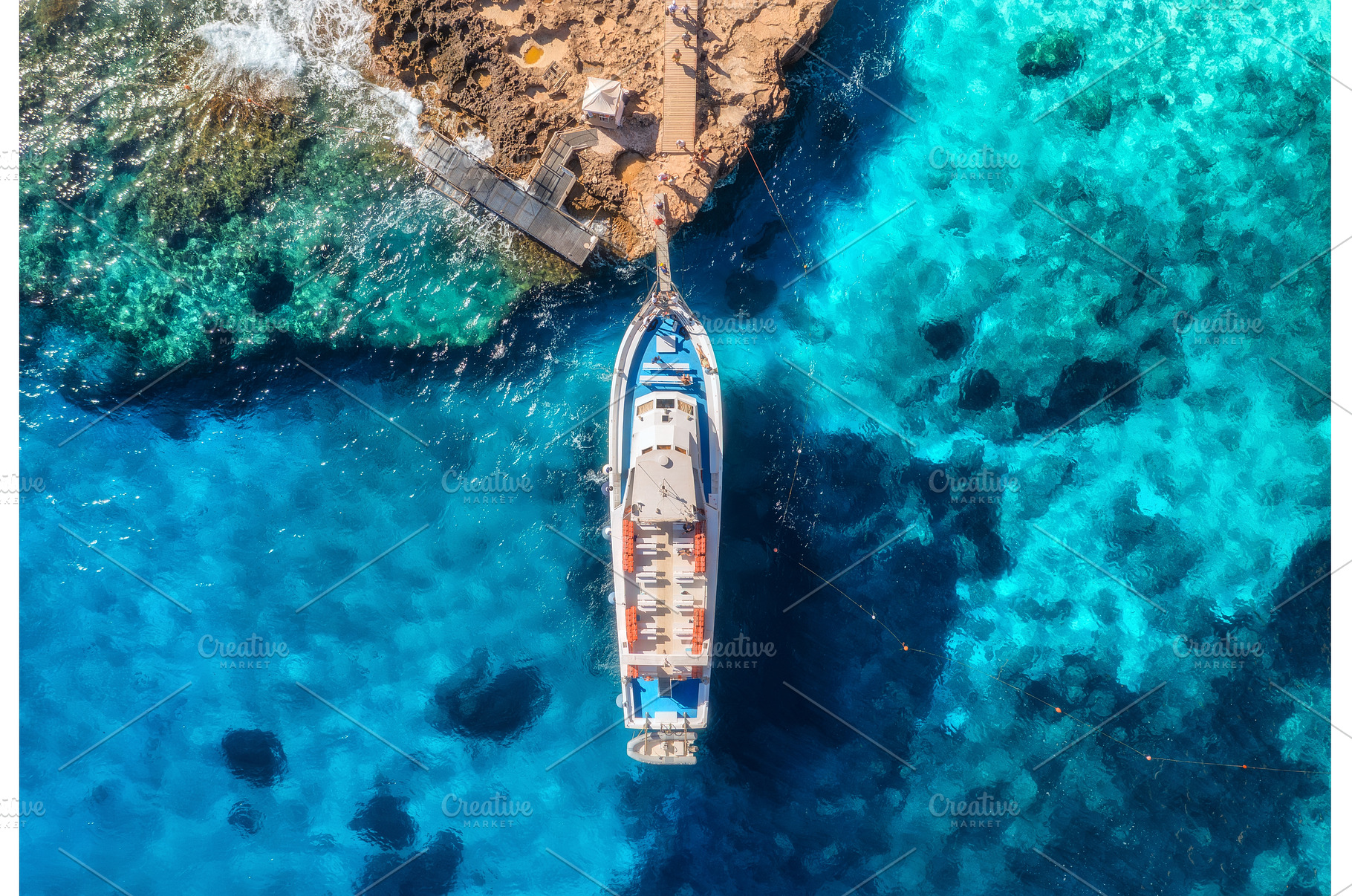 Aerial view of boat and rocky sea, a Nature Photo by den-belitsky