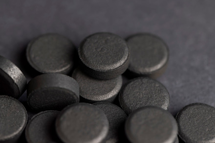 Open and unpacked tablets of black color close-up, a Background Photo by MyPhotos