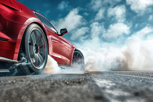 Red sport car wheel drifting and smoking, a Transportation Photo by AlyaAnd