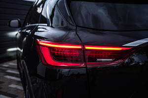 Modern Black Car Rear Taillight Close Up at Night, a Transportation Photo by Red Hot Chili Pepper Shop
