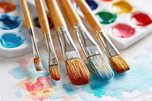 Colorful paintbrushes and palette on watercolor background, an Arts & Entertainment Photo by AlyaAnd