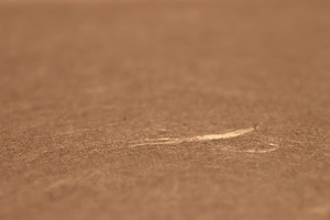 Close-up of a scratch on a brown paper texture surface., a Texture Graphic by Textures & Backgrounds
