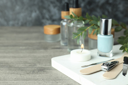 Concept of nail care with manicure accessories on gray wooden ta, a Beauty & Fashion Photo by AtlasStudio