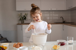 Child girl making cake