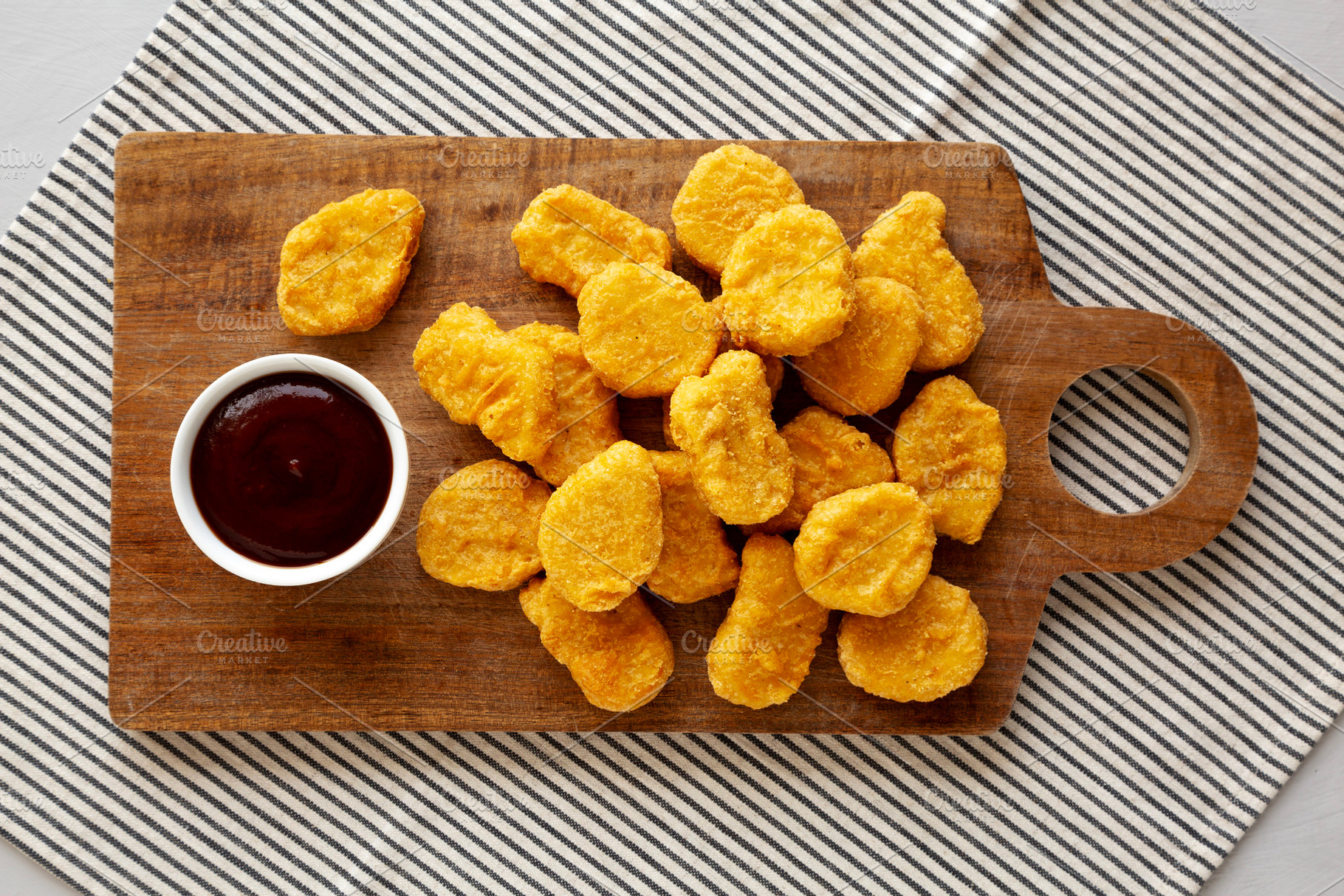 Organic Fried Chicken Nuggets on a wooden board, top view. Overh, a Food & Drink Photo by LiudmylaChuhunova