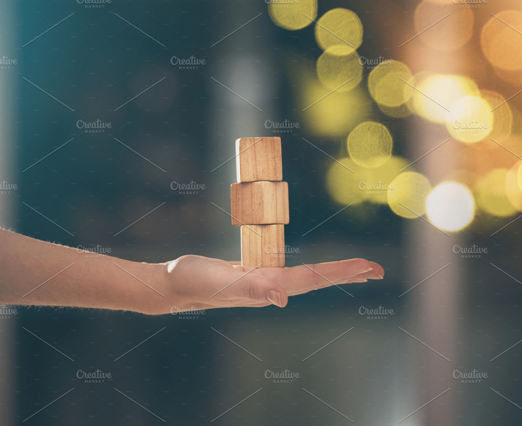 Hand, building blocks and balance with a business woman holding wood for growth on a blurred background. Investment, portfolio and stack with the foundation of a company built on financial stability, a Photo by Peopleimages.com