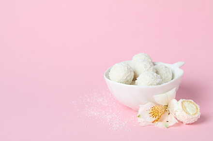 Concept of tasty sweets, coconut candies, space for text, a Food & Drink Photo by AtlasStudio PRO
