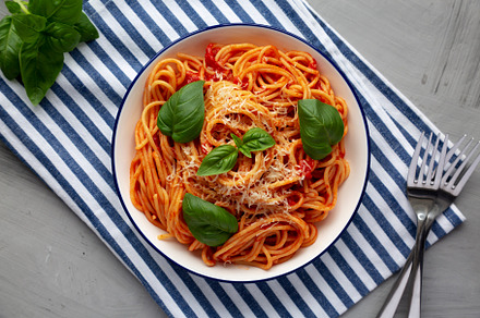 Homemade Pasta Pomodoro on a Plate, top view. Flat lay, overhead, a Food & Drink Photo by LiudmylaChuhunova