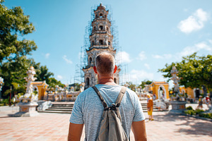 Standing in front of a historic monument during a sunny day in a bustling court, a Person Photo by AlyaAnd