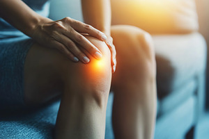 Man with glowing knee pain, a Photo by AlyaAnd