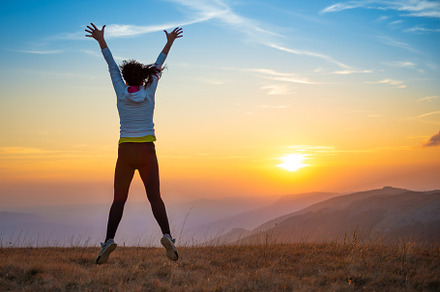 Young woman jumping at sunset mountains, a Person Photo by Vapi