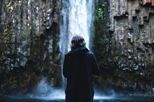 Girl in Coat with Waterfall