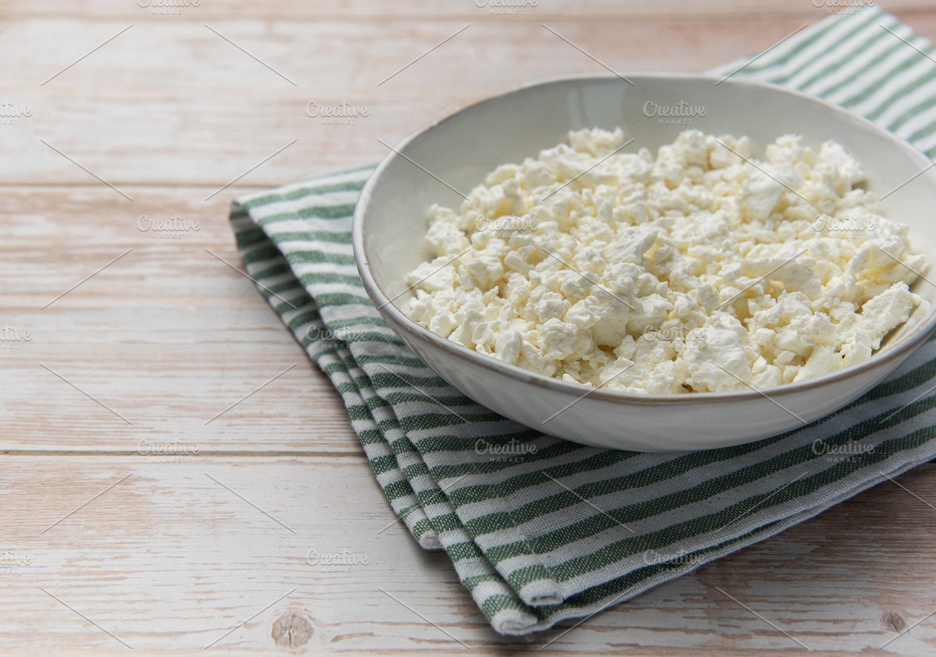 Fresh natural cottage cheese on wooden background with napkin, a Food & Drink Photo by Olena Rudo