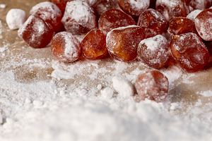 candied fruits of kumquat boiled in sugar syrup in powdered sugar, sweet dehydr, a Photo by rsoollAI