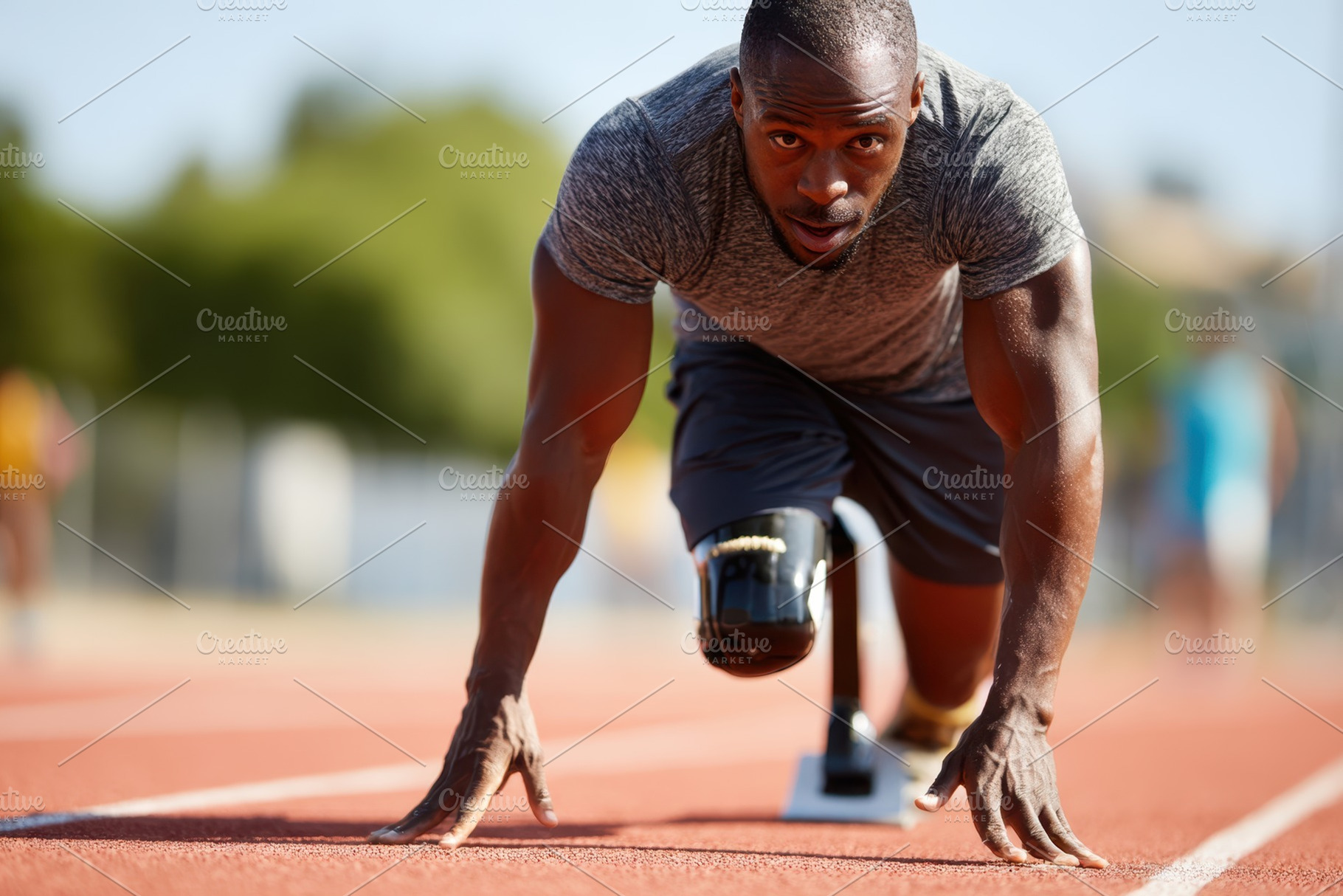 Determined athlete with prosthetic leg ready to sprint, a Sports & Recreation Photo by AlyaAnd