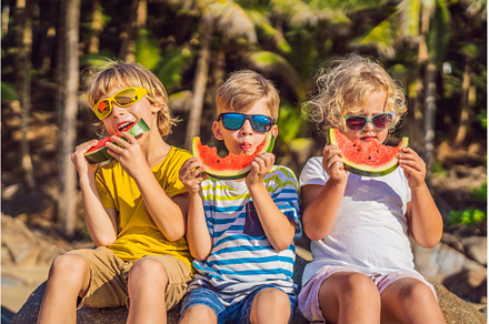 Children eat watermelon on the beach, a Person Photo by Elizaveta Galitskaya