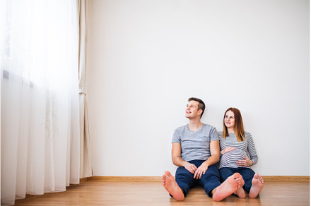 Pregnant woman and her partner, a Person Photo by HalfPoint