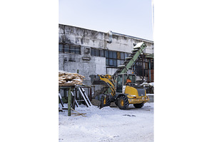 Loader moving wood chips using a, an Industrial Photo by volodymyrshtun13795