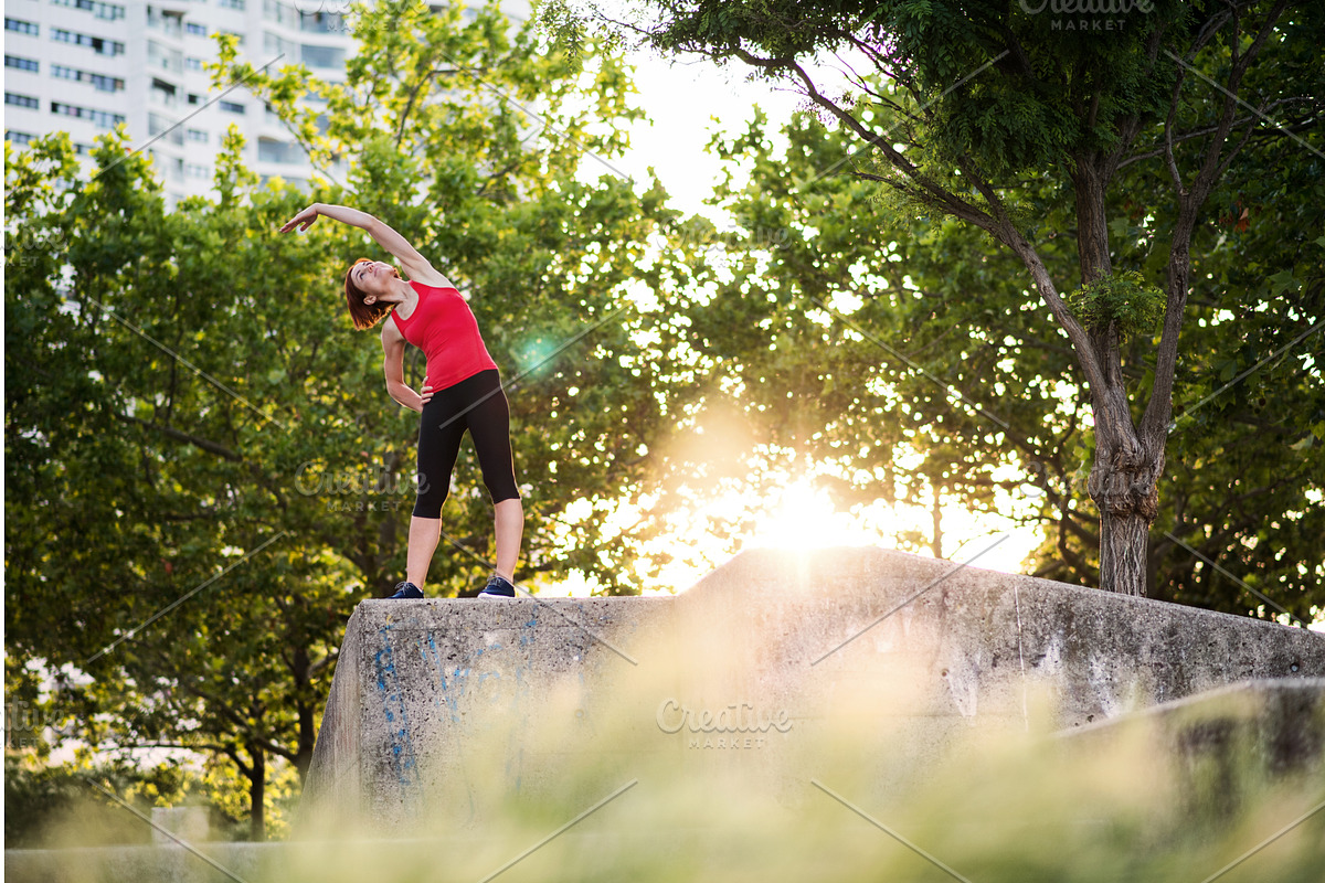 Young woman doing exercise outdoors, a Graphic by HalfPoint