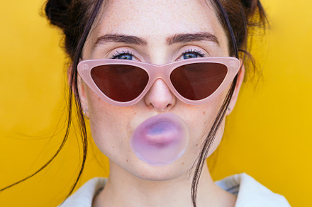 woman blowing a bubble gum bubble on, a Person Photo by Harry Rendón