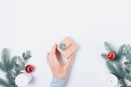 Woman's hand holding Christmas gift box, a Holiday Photo by progressman
