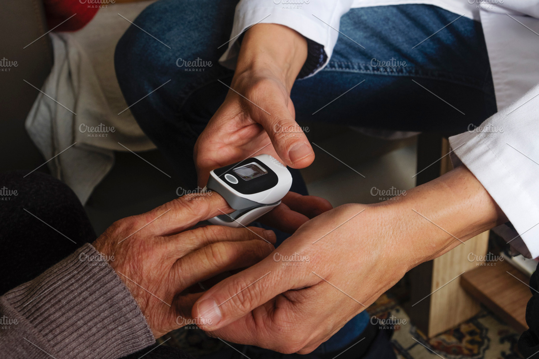 a healthcare worker checks oxygen saturation, a Photo by Nito