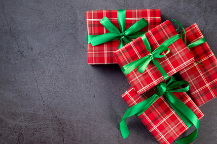 Red gift boxes with green ribbon at dark background., a Holiday Photo by vimart