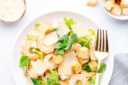 Gourmet Caesar salad with shrimp, iceberg and lettuce, croutons,, a Food & Drink Photo by 5PH
