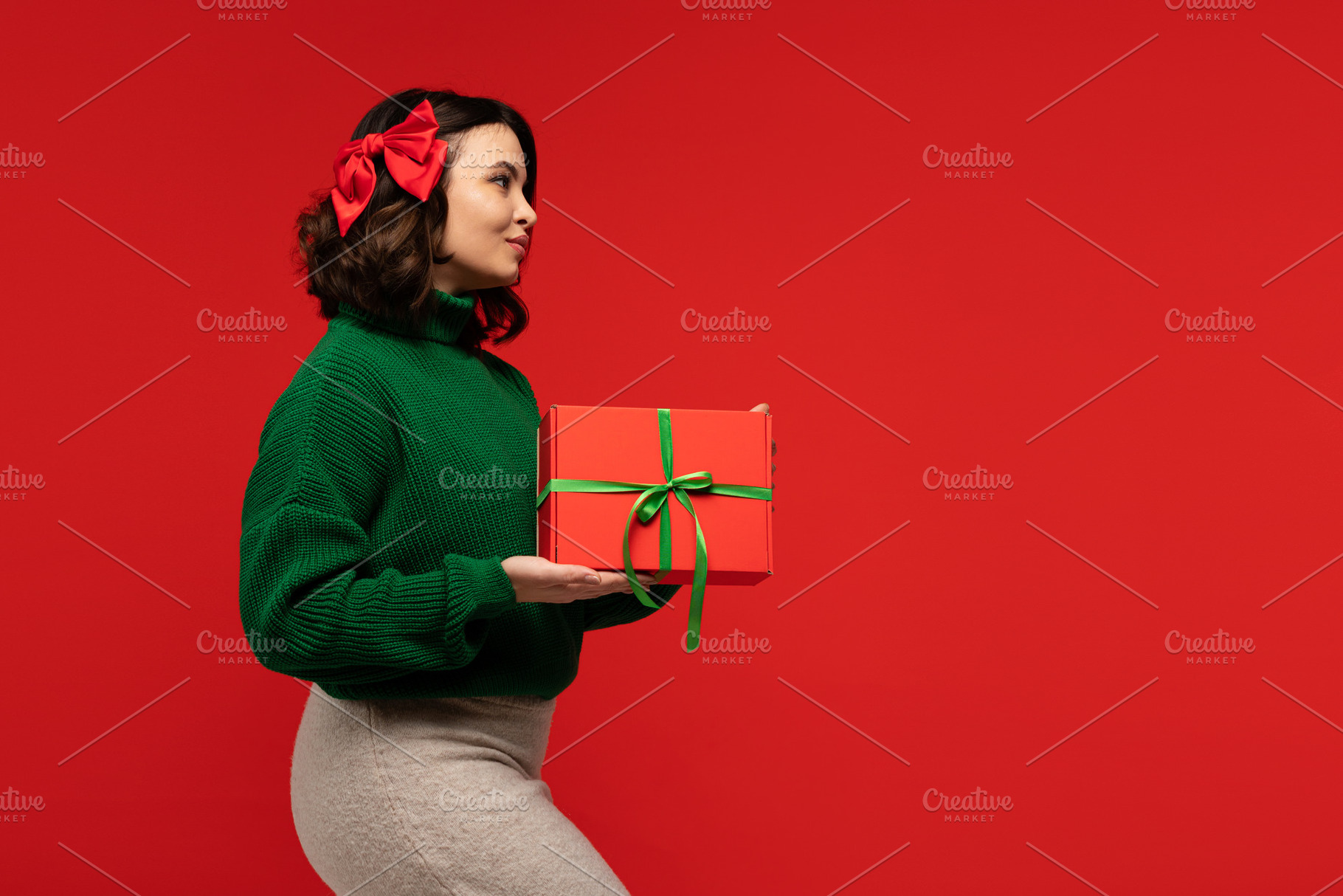 Woman in green sweater and bow, a Holiday Photo by Elena Vagengeim