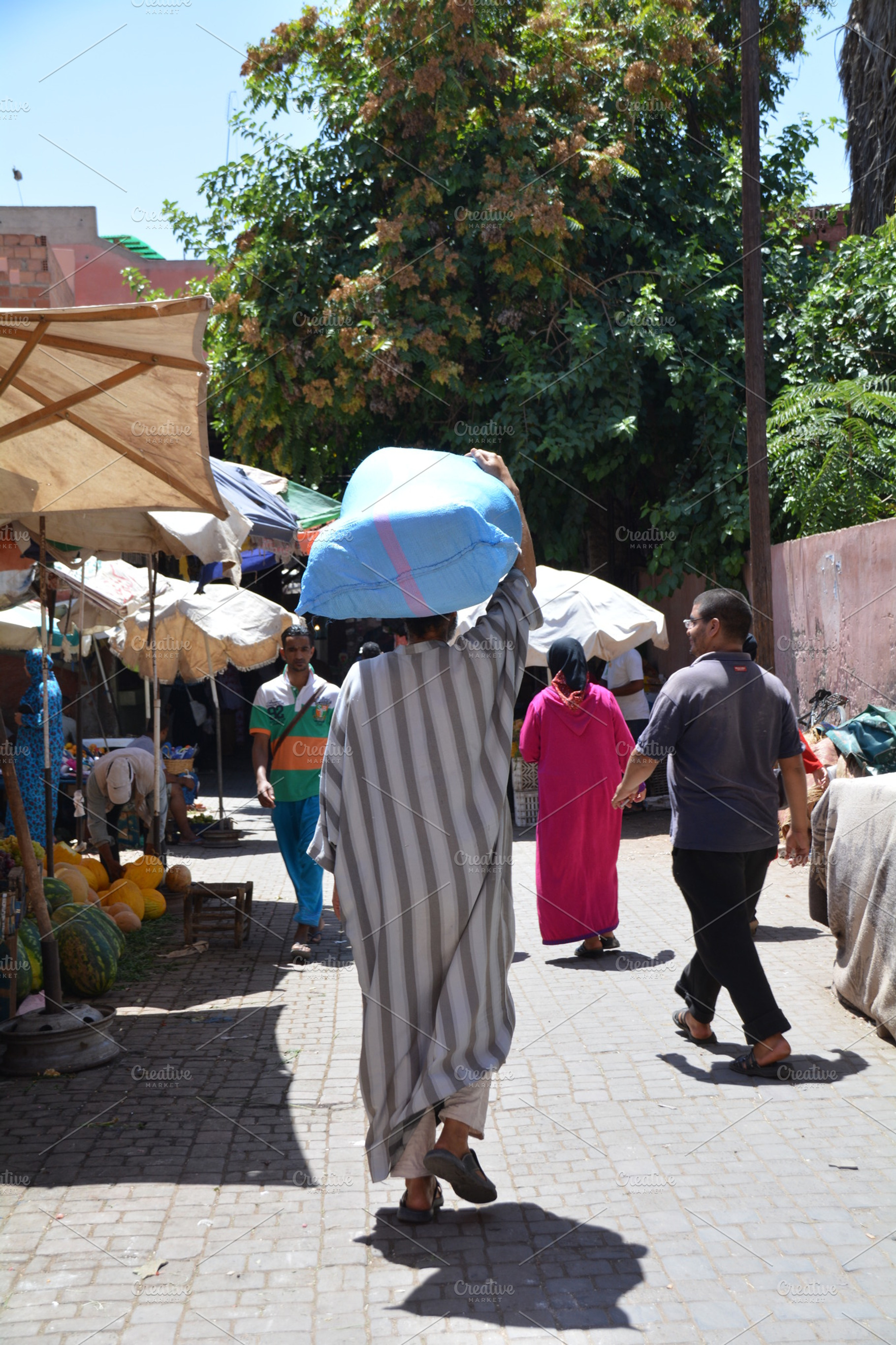 Man carrying a bag on arabian market, a Person Photo by Beavergraphy