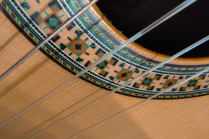 Close-up, high-angle detail shot of a classic spanish guitar, an Arts & Entertainment Photo by DanFLCreativo