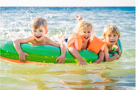 Children swim in the sea on an, a Person Photo by Elizaveta Galitskaya