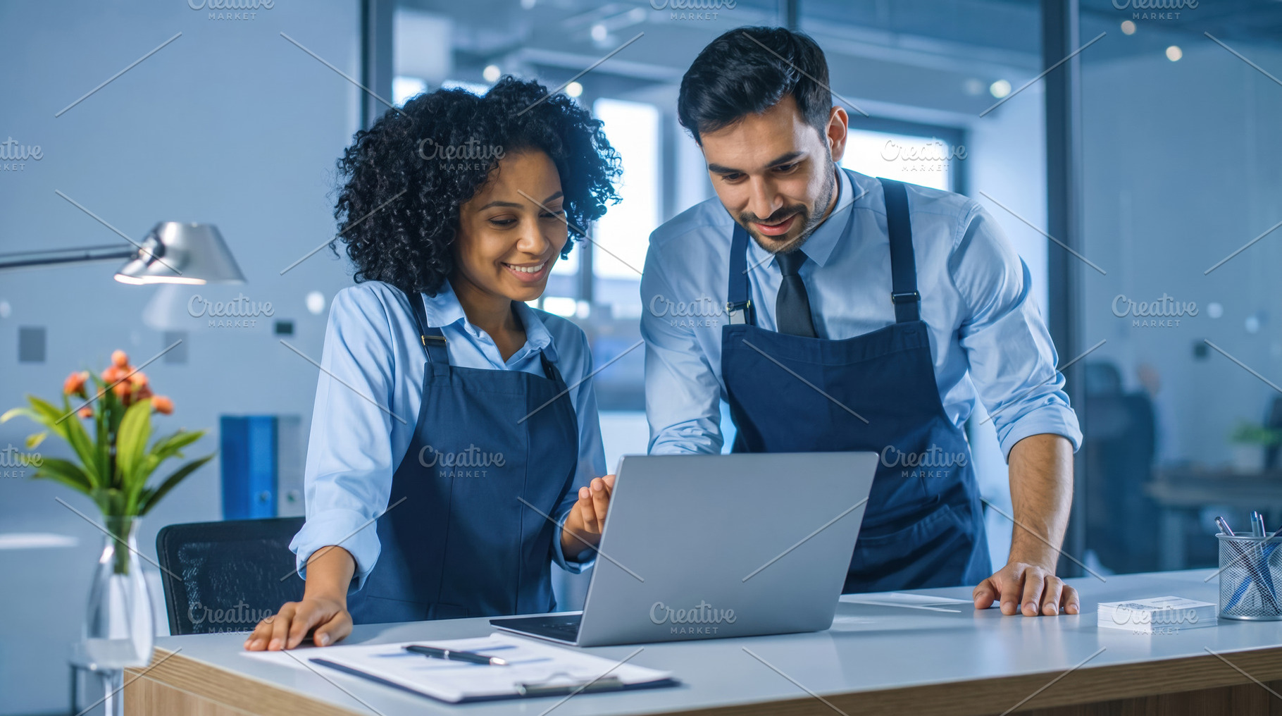 Retail Staff Reviewing Laptop in Modern Store, a Business Photo by Davizro's Market