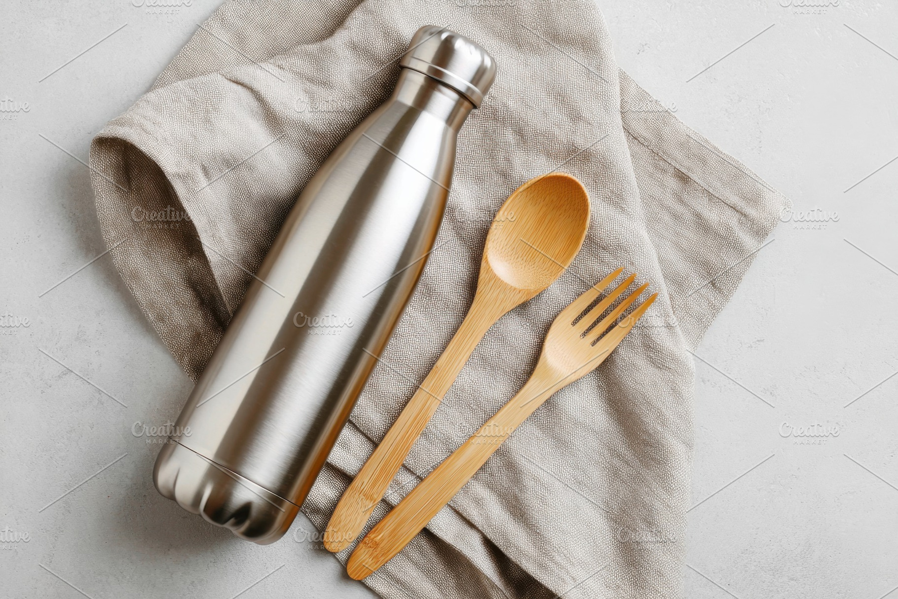 Stainless steel water bottle with bamboo utensils, a Food & Drink Photo by AlyaAnd