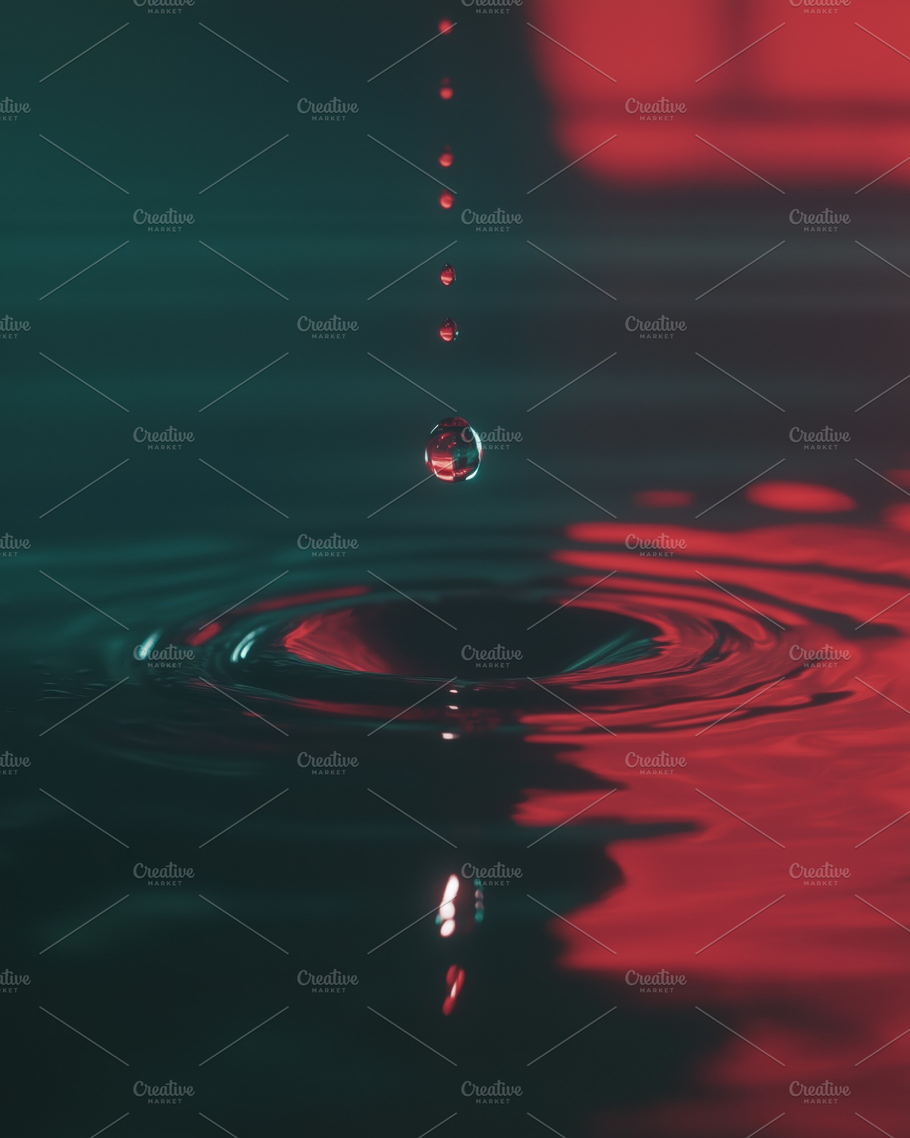 A close-up view of water droplets falling into a pool of water, creating ripple, a Photo by Textures & Backgrounds