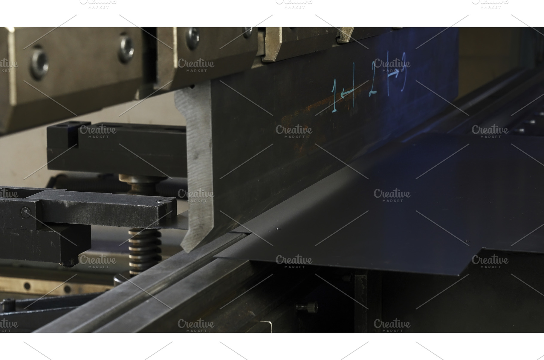 A metal sheet placed on a machine, an Industrial Photo by Media Whale Stock