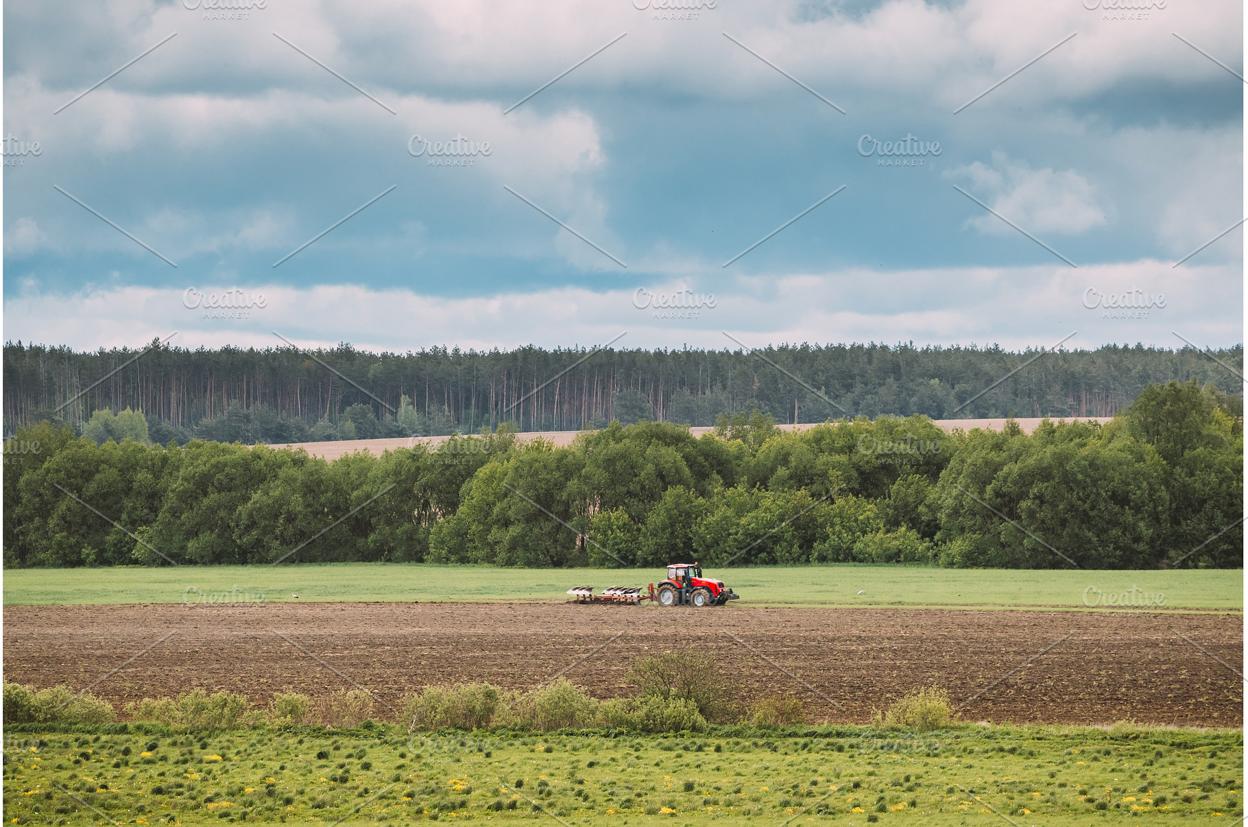 Tractor Plowing Field In Spring, an Industrial Photo by Our Amazing World