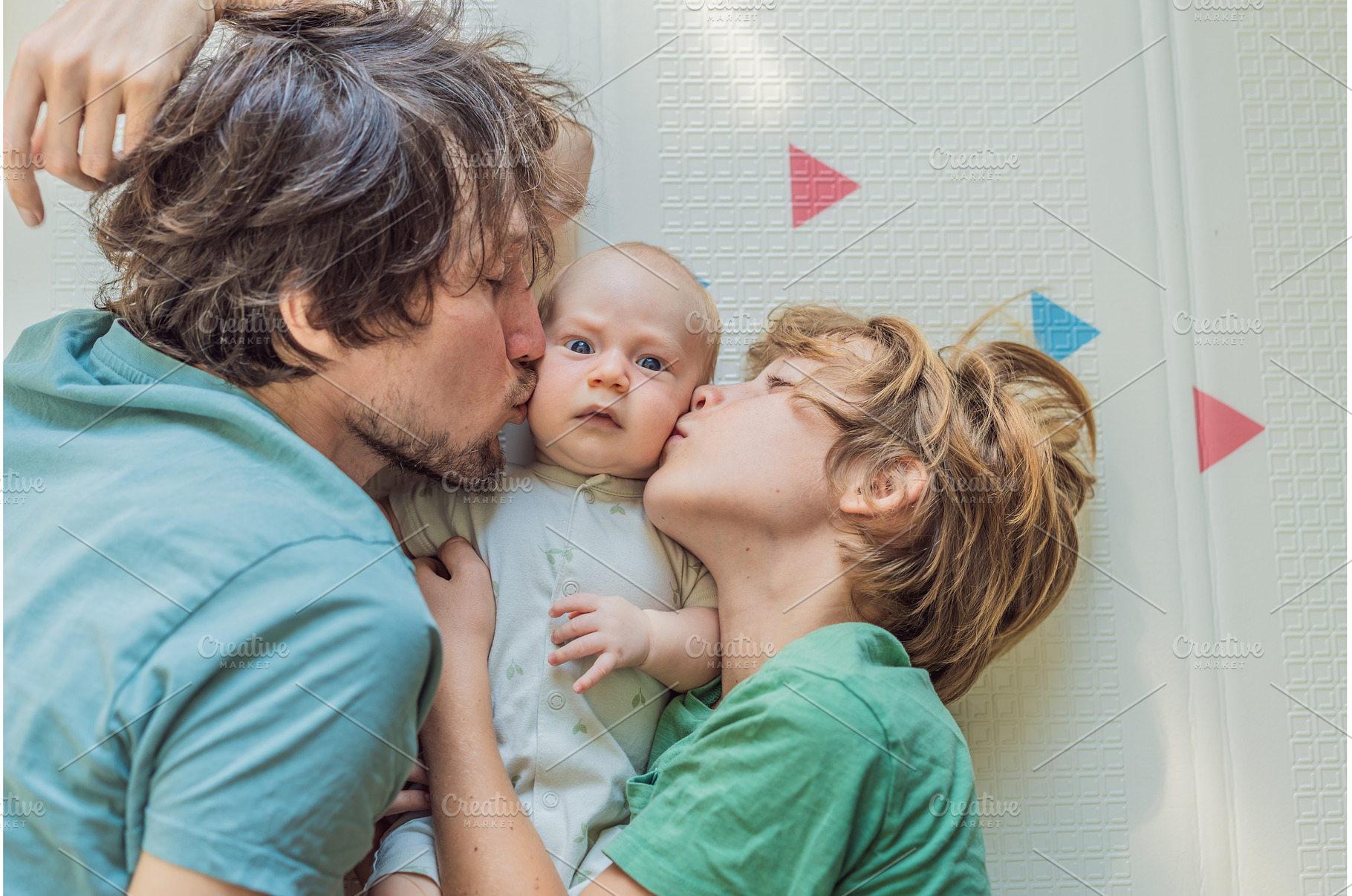 Father, son, and newborn baby lying, a Person Photo by Elizaveta Galitskaya