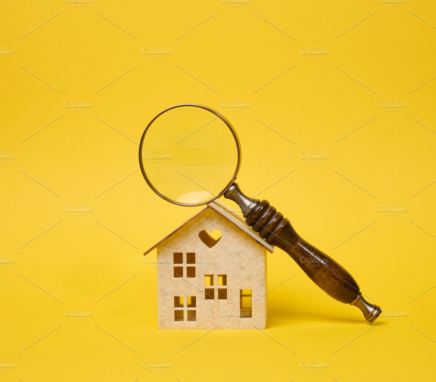 Magnifying glass with a wooden handle lying on a decorative toy, a Business Photo by ndanko