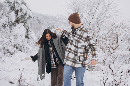 A young happy and loving couple walking in a snowy forest in the, a Person Photo by Cherkas Photography