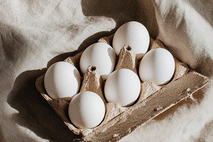 White eggs in cardboard tray, a Food & Drink Photo by Virgo Studio