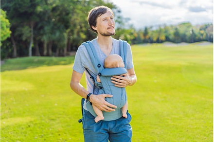 Young father walks in nature with