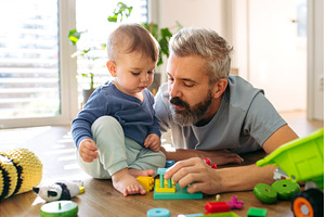 Father playing with little son with, a Person Photo by HalfPoint